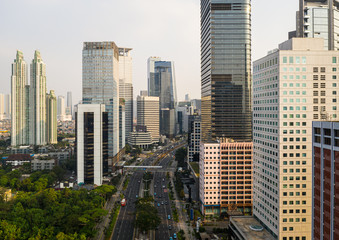 Naklejka na ściany i meble Modern skyscrapers and luxury condo towers in the heart of Jakarta business district along Sudirman street in Indonesia capital city