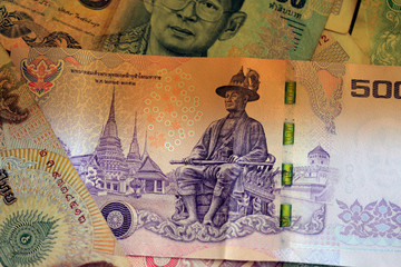 Thai baht banknotes close up. Money background brown color toned