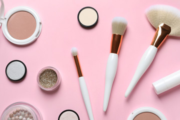 Flat lay composition with makeup brushes on pink background