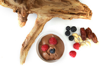 Fuite and mousse on flat wood and white background. A breakfast ready to be served, Raw and organic food
