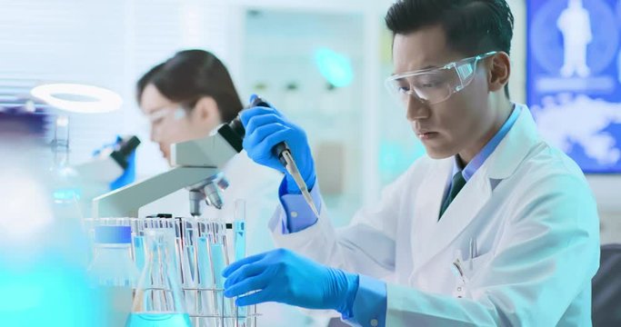 Asian scientist take test tube