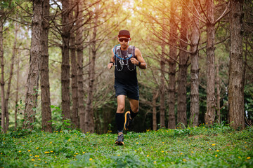 Naklejka na ściany i meble A man Runner of Trail and athlete's feet wearing sports shoes for trail running in the forest