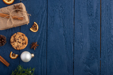 Christmas or New Year.Christmas gifts.Toys and coniferous branches. With space for design, on a background of blue wood. Christmas mood and warmth.