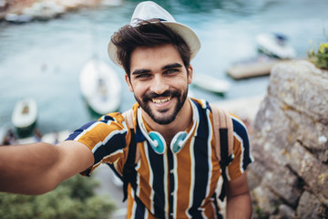 Man taking self portrait in the europe streets.Travel selfie.