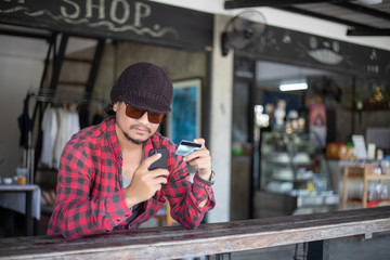 Man asian using phone and credit card shopping online