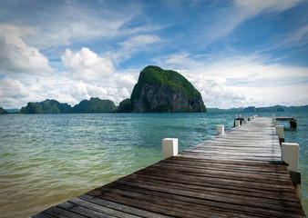 Obraz premium Far view of Miniloc Island from a little pier at Las Cabañas Beach, El Nido, Palawan Province, Philippines