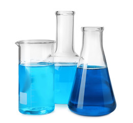 Laboratory glassware with blue liquids isolated on white