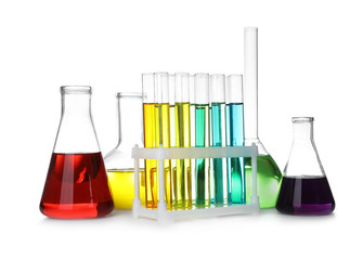 Laboratory glassware with color liquids on white background