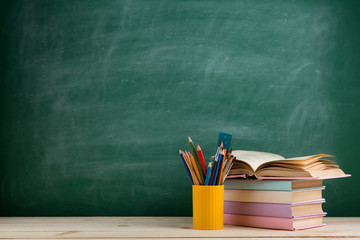 Education and reading concept - group of colorful books on the wooden table in the classroom,...