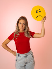 Beautiful young woman holding angry face emoji in social media notification icons