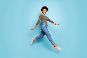 Full body photo of dark skin pretty lady jumping high walking down spring foreign street charming...