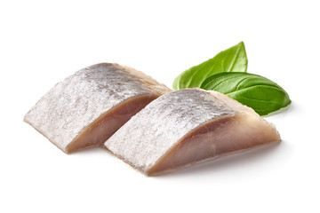 Salted herring with fresh green basil, isolated on white background