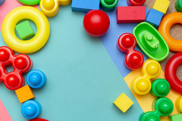 Colorful child kid’s education toys pattern background copy space mockup on the bright color background. Childhood education infancy children baby concept. Flat lay, top view, close up
