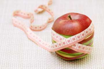 An apple and flexible ruler as a concept of dieting and weight control	