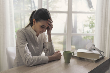 Sad tired woman drinking coffee