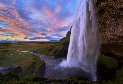 Stunning sunset at seljalandsfoss, iceland with flowing waterfalls © hafizanwar