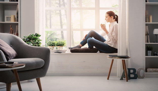 Woman Relaxing At Home And Having Coffee