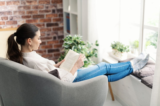 Woman Relaxing And Reading A Book