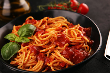 Plate of delicious spaghetti Bolognaise or Bolognese with savory minced beef and tomato sauce garnished with parmesan