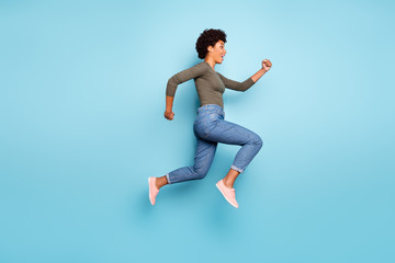 Fototapeta na wymiar Full length body size photo of cheerful charming cute jumping fast quick woman running towards shopping mall for sales wearing jeans denim isolated over vivid color blue background