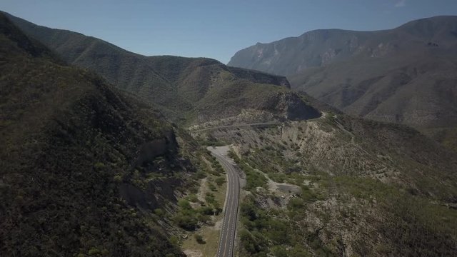 DRONE REVEAL: Windy roads through Tehuacan Landscape along Highway 135D from Puebla to Oaxaca in Mexico.