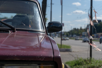 Close-up of an old vintage car on a street on a summer day