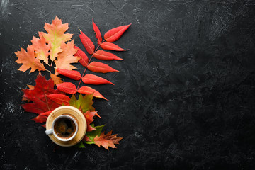 Cup of hot coffee and colored autumn leaves. flat lay. In the old background. Top view. Free space for your text.