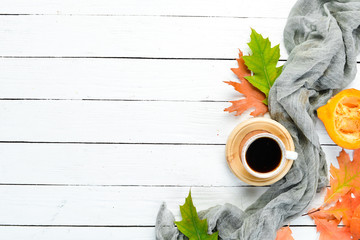 Cup of hot coffee and colored autumn leaves. flat lay. In the old background. Top view. Free space for your text.