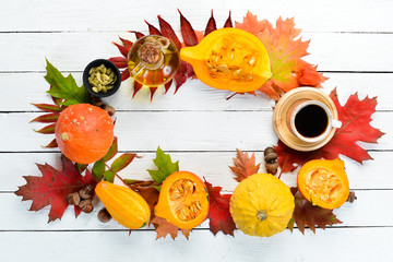 Autumn background with coffee, pumpkin, autumn leaves. flat lay. On a white wooden background. Top view. Free space for your text.