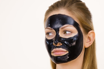 Girl black carbo peel off mask on face