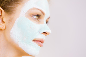 Girl with white green mud mask on face