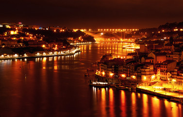 Fototapeta na wymiar Porto, Portugal old town ribeira with night light, Douro river. Night view aerial perspective landmark.