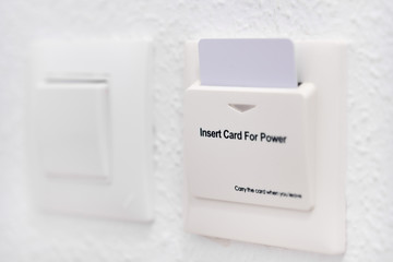 Close up view home or hotel room white wall with card reader and card holder for energy saving switch