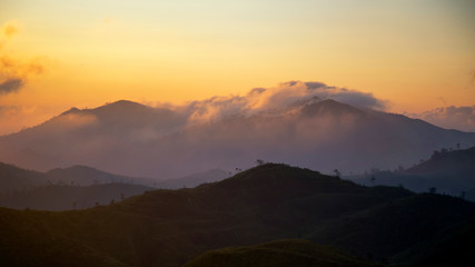 Landscape of the sunrise over the mountain with fog in the morning at Kanchanaburi provice , Thailand.