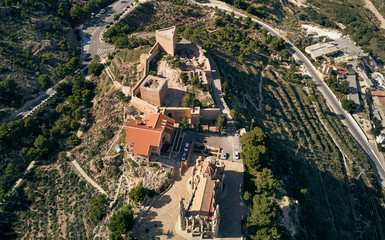 Fototapeta na wymiar Aerial drone point of view directly from above Sanctuary of Santa Maria Magdalena monastery rooftop and surroundings countryside located in Novelda town, spanish Art Nouveau masterpiece, Spain