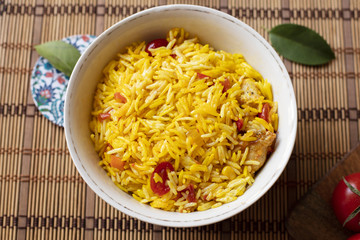 Top view bowl of rice with tomatoes