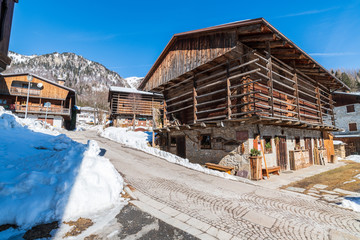 Fototapeta na wymiar Winter in Sauris di Sotto. Magic of snow and old wooden houses. Italy