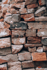 A lot of old bricks. Red and orange bricks texture. Photo background with ruined brickwork.