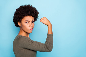 Photo of black millennial girl showing you her biceps thinking on result boasting about her...