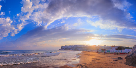 	 Panoramic view of the bay of Peschici at sunrise: the old town and the sandy beach, Italy...