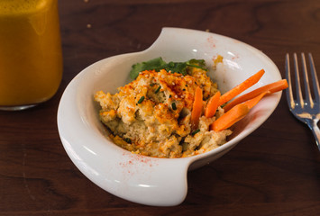 Hummus with carrot and sesame sticks. Healthy dish close-up
