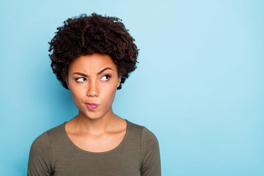 Hmm... interesting. Portrait of serious expression emotions minded afro american girl think try to solve decide solutions be creative wear good look outfit isolated over blue color background
