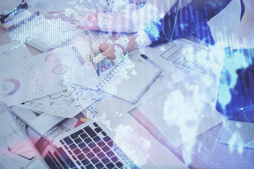 A woman hands writing information about stock market in notepad. Forex chart holograms in front. Concept of research. Double exposure