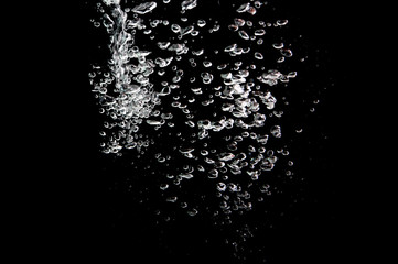 water splash with bubbles of air, isolated on a black background.
