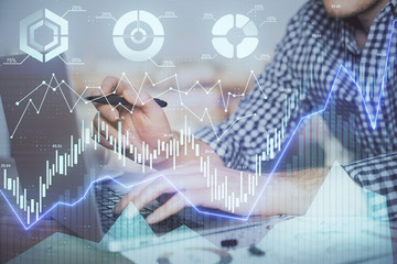 Double exposure of forex graph with man working on computer on background. Concept of market analysis.