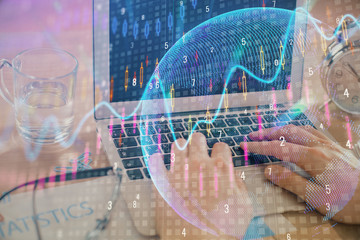 Double exposure of market chart with man working on computer on background. Concept of financial analysis.