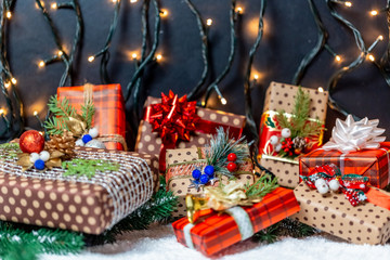 Christmas presents with branches Christmas tree on a snow. Christmas gifts on bokeh background