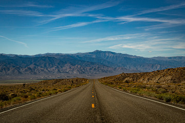 Long and Lonely road in the desert of Nevada leading towards a mountain range with nobody around (2)