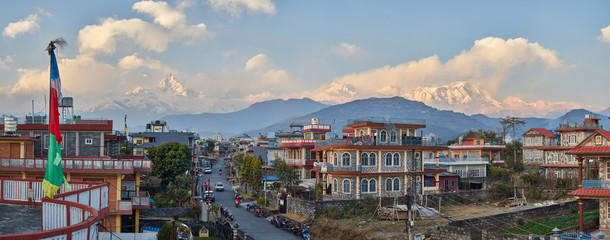 Panorama of sunset Pokhara in the Rambazar district, on the background of the Himalayan ridge with the majestic Machapuchare, which is part of the Annapurna massif. Nepal