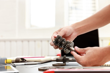 Engineer discussing and designing about mechanical gear parts in office.